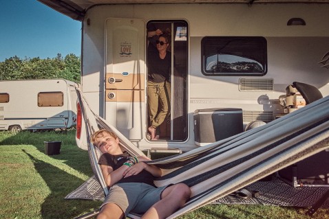 A family relaxes in their caravan at Camperpark Amsterdam